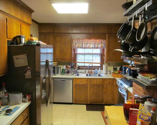 Before photo of a kitchen remodel project with marble countertops with brick chimney