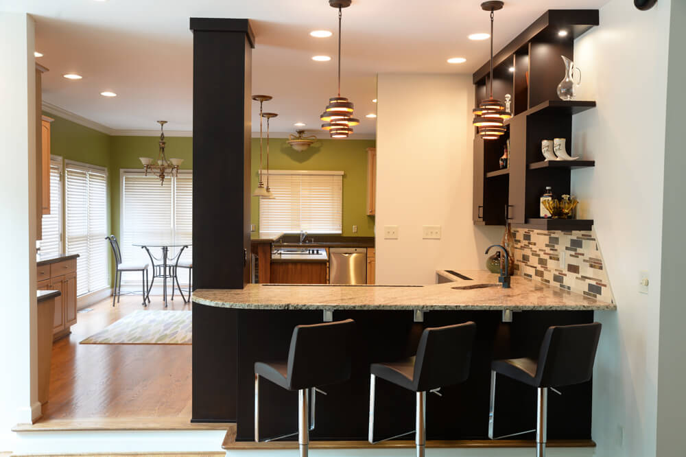 after photo of a kitchen remodel with arble coutertop and leather stools