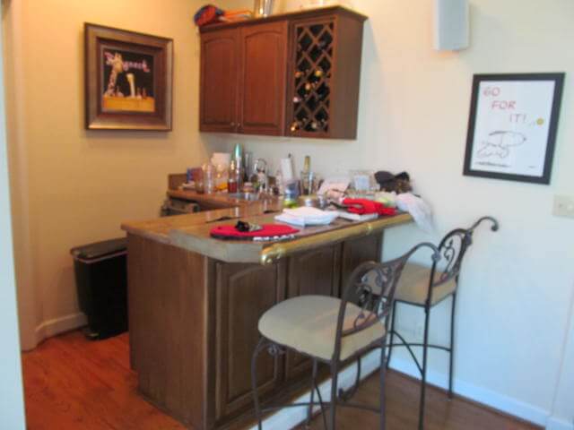 before photo of small bar counter area with stools and small wine rack