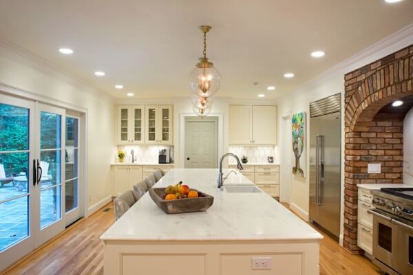 remodeled kitchen island with three matching orb lights and stianless steel sink