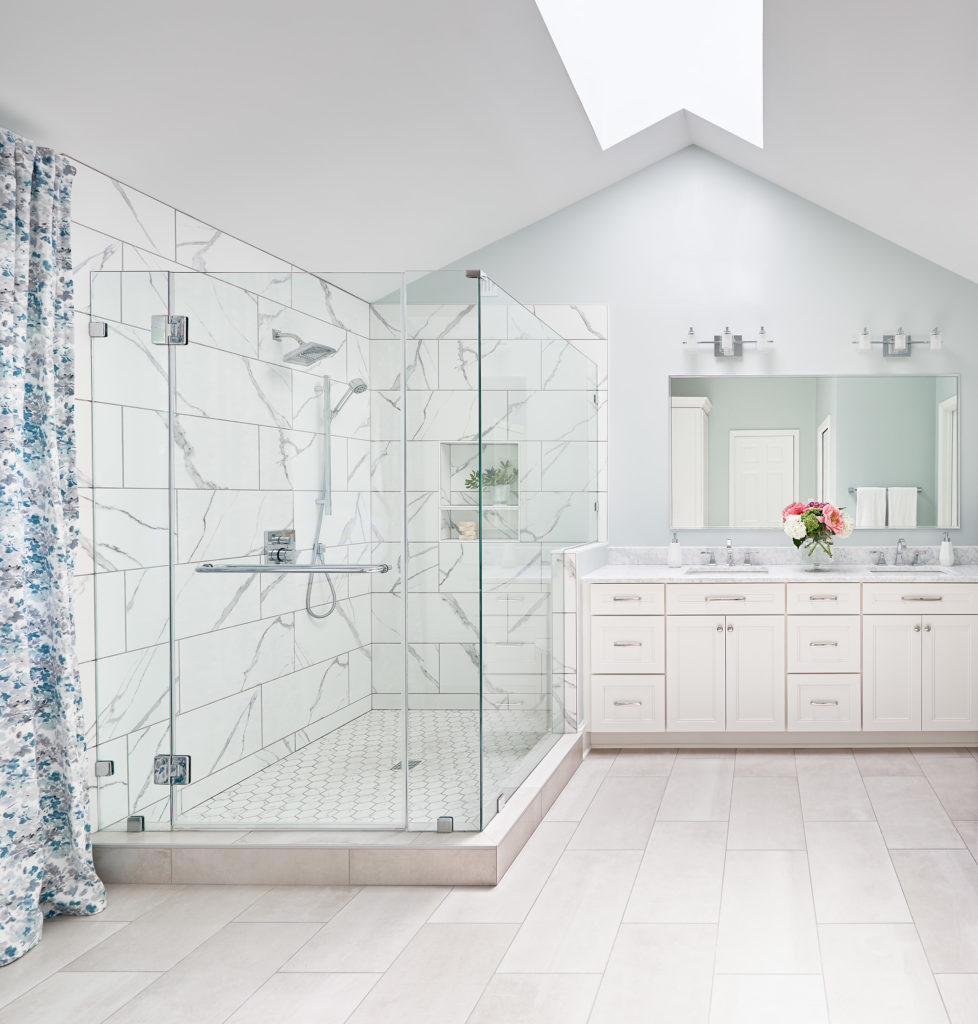 bright bathroom renovation skylight white walls glass shower double sink vanity single mirror