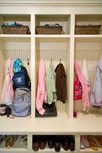 Custom built-in dropzone with shoe storage, upper shelves and cubbies with hooks