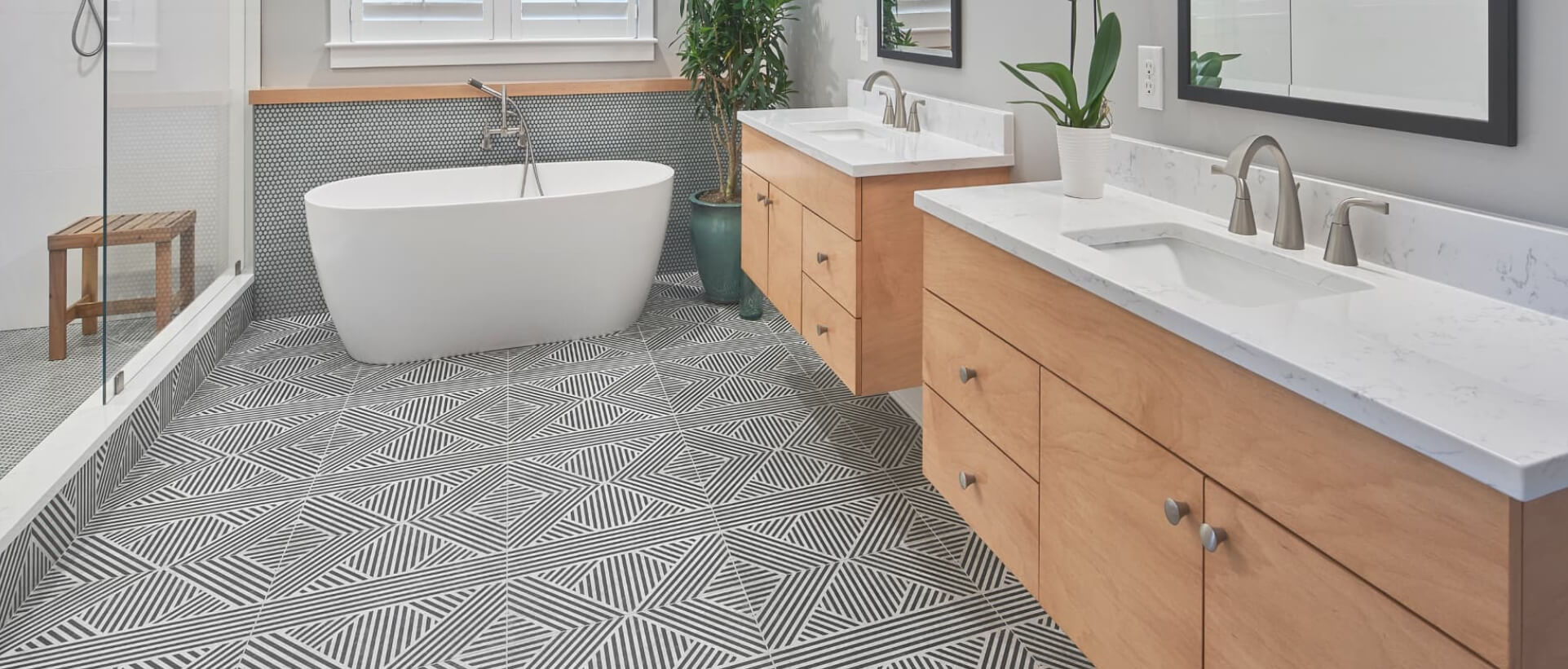 bathroom renovation double floating vanities freestanding garden tub on tribal pattern tile floor
