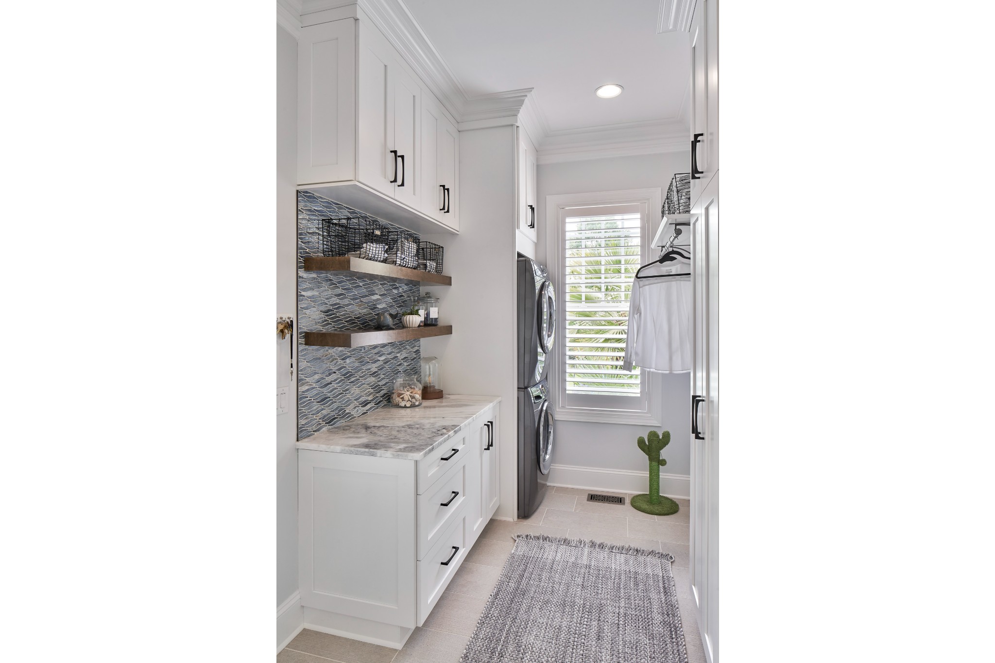 Large casual coastal laundry room renovation with custom cabinetry and countertop space