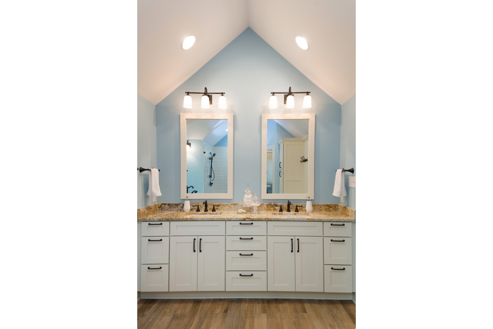 Vaulted bathroom with large double vanity and maximized storage