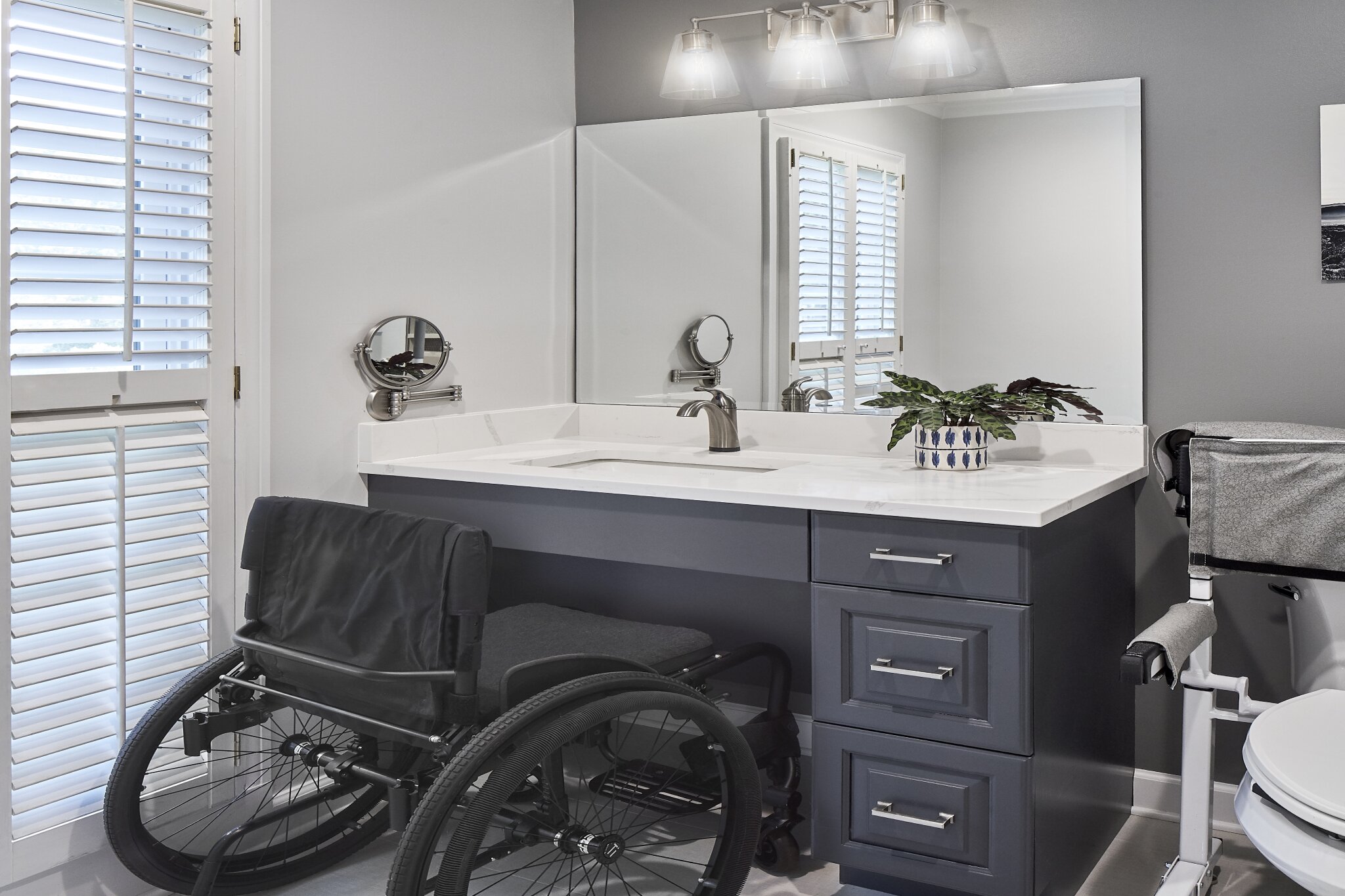 Universal design bathroom renovation with handicap-accessible floating vanity and oversized mirror