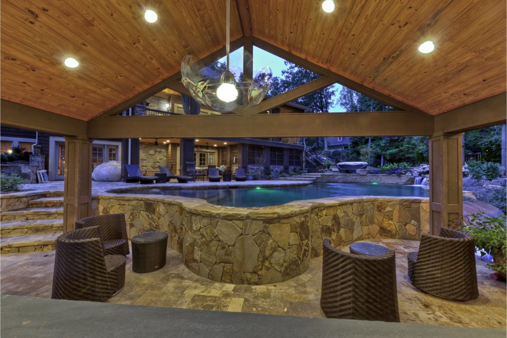 Porch home addition with recessed lighting and view of pool.