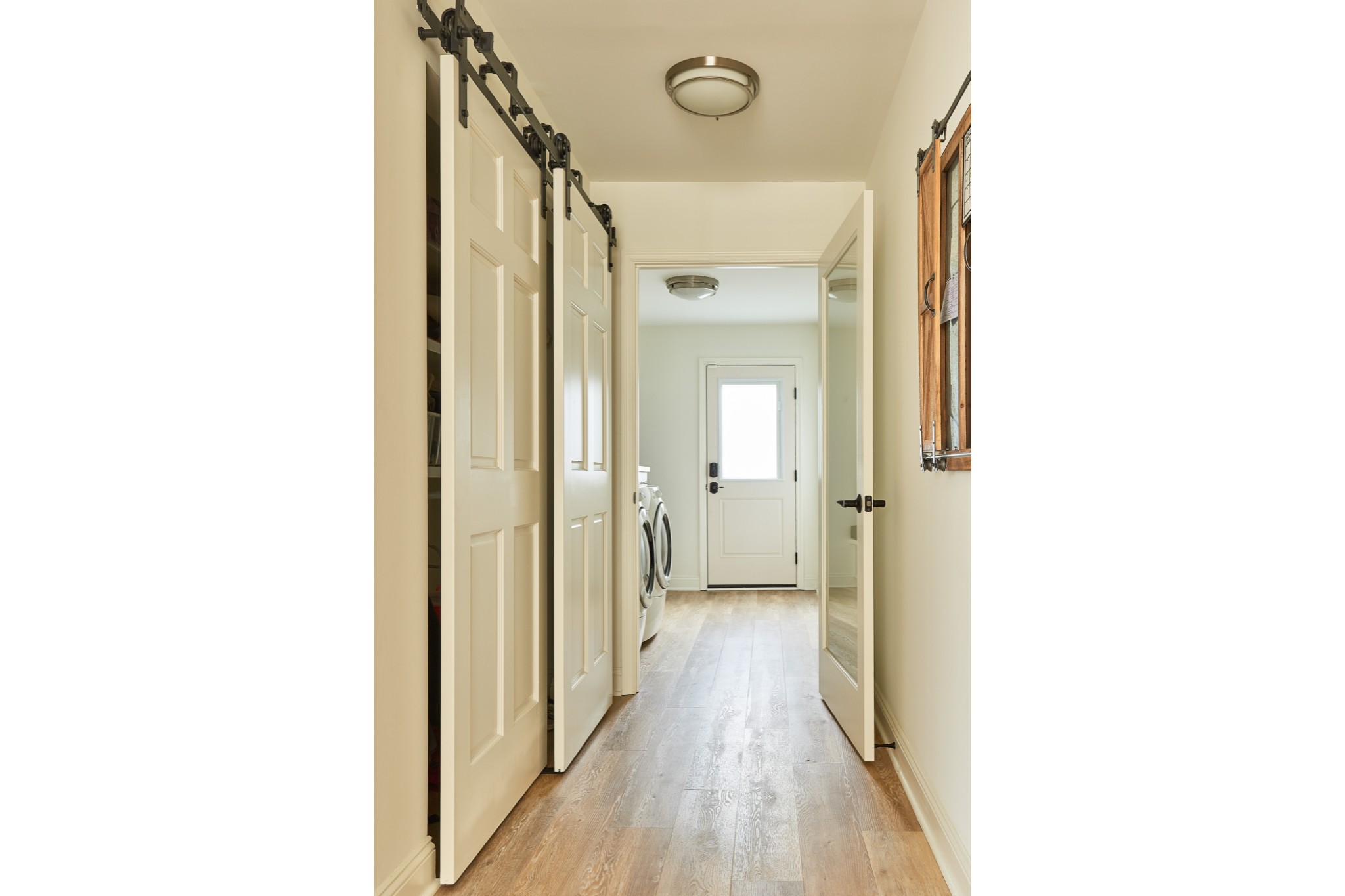 modern farmhouse hallway renovation sliding closer doors leads to laundry room hardwood flooring