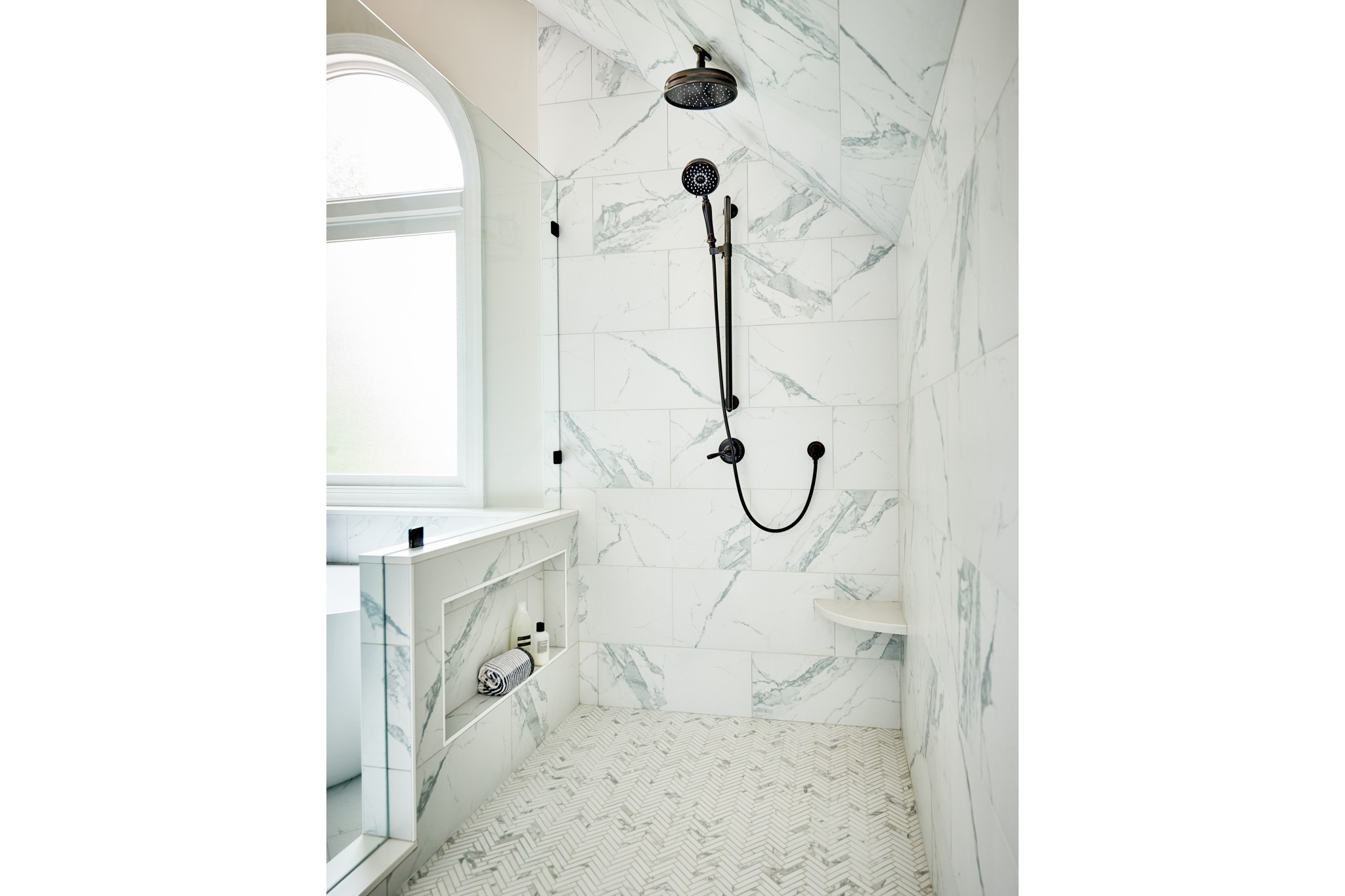 bright bathroom renovation granite tile on walls chevron tile in shower black finishes