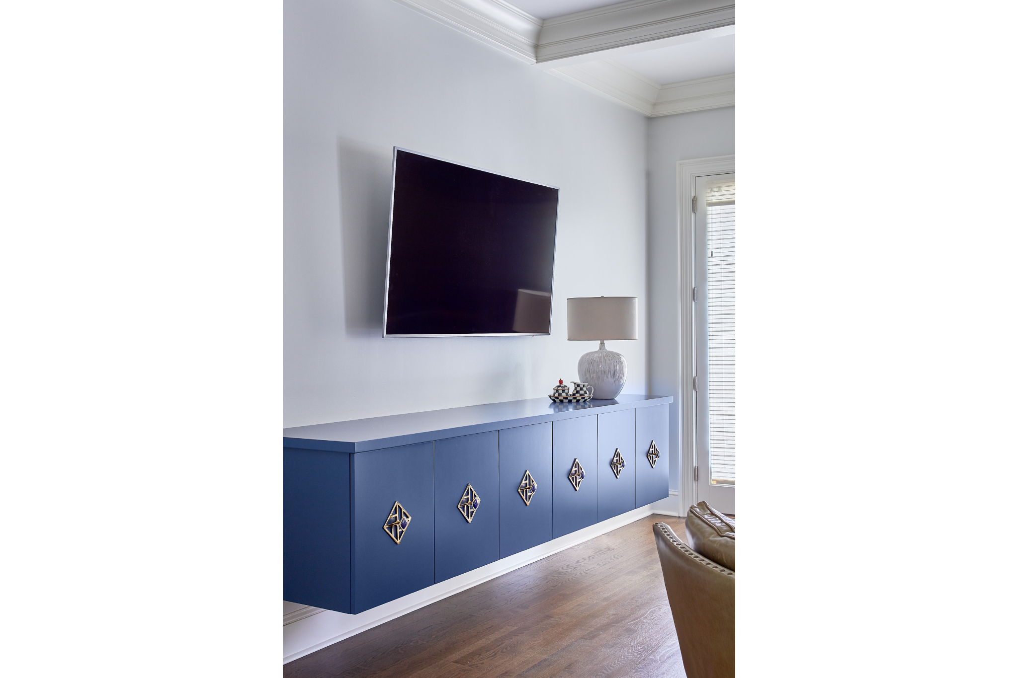 Modern blue floating media console/cabinets with intricate gold handles