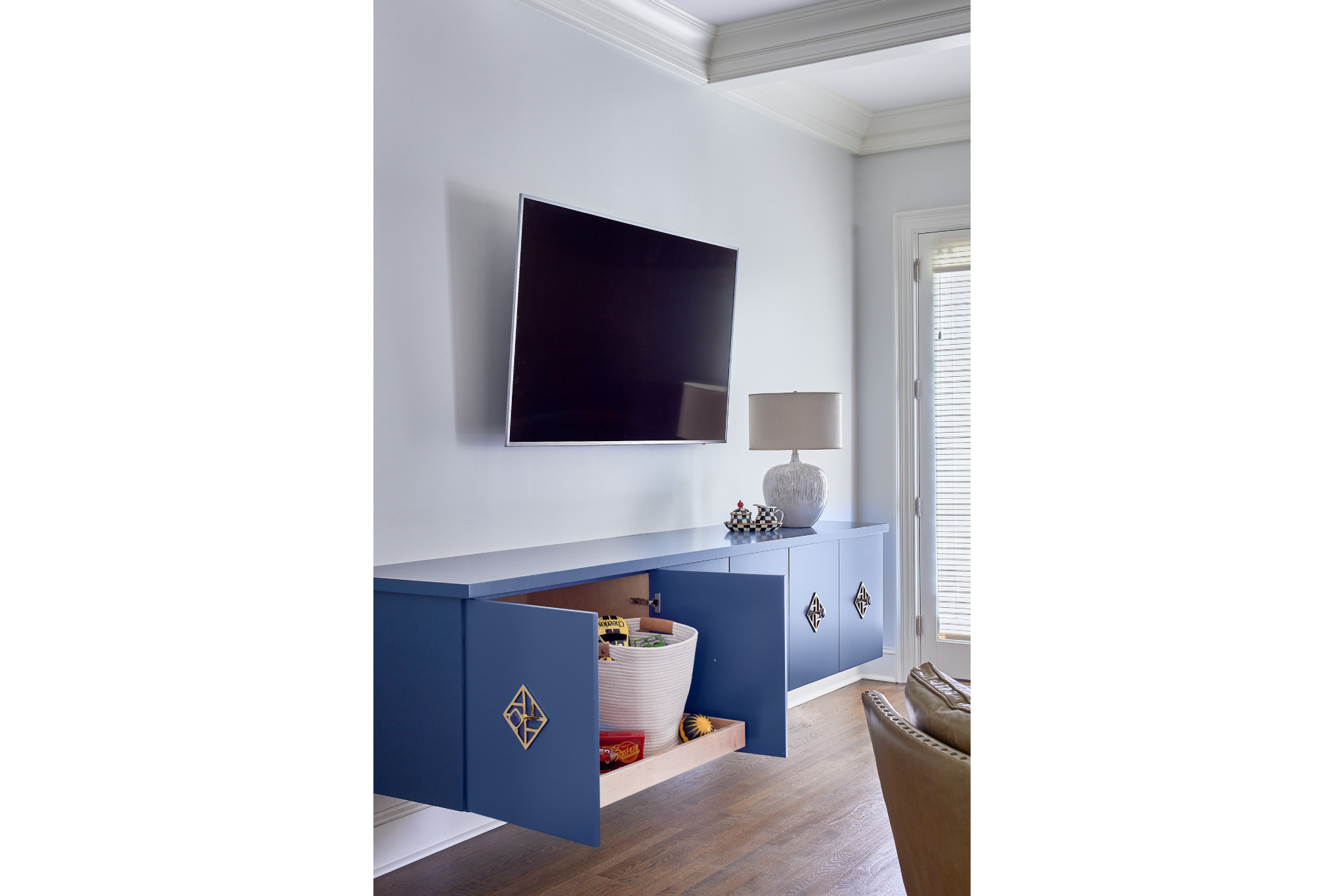 Modern blue floating media console/cabinets with intricate gold handles
