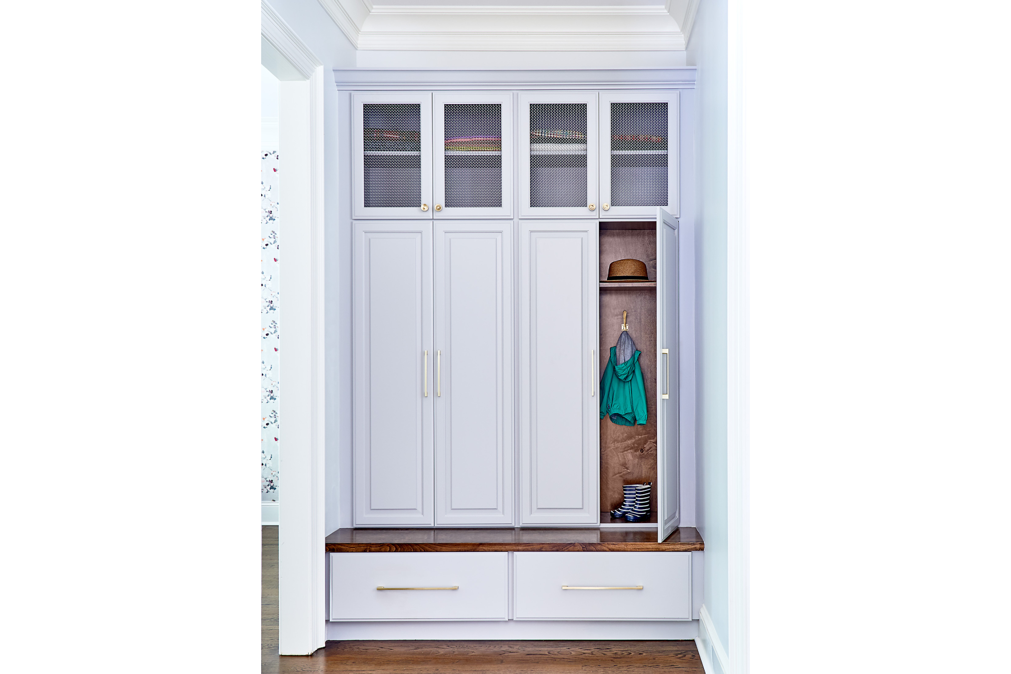 Custom mudroom built-in with tall storage cabinets and bench seating