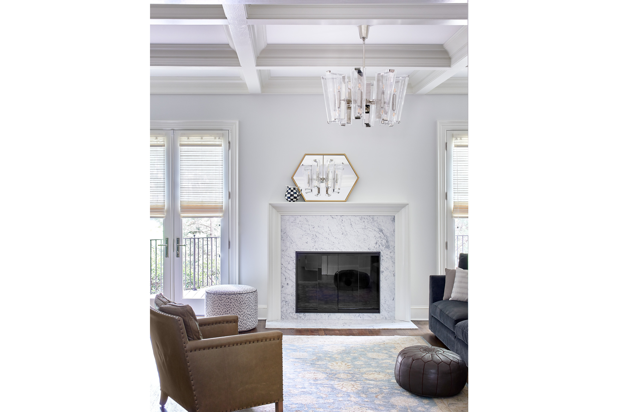 Muxury living room renovation with a marble fireplace and crystal light fixture