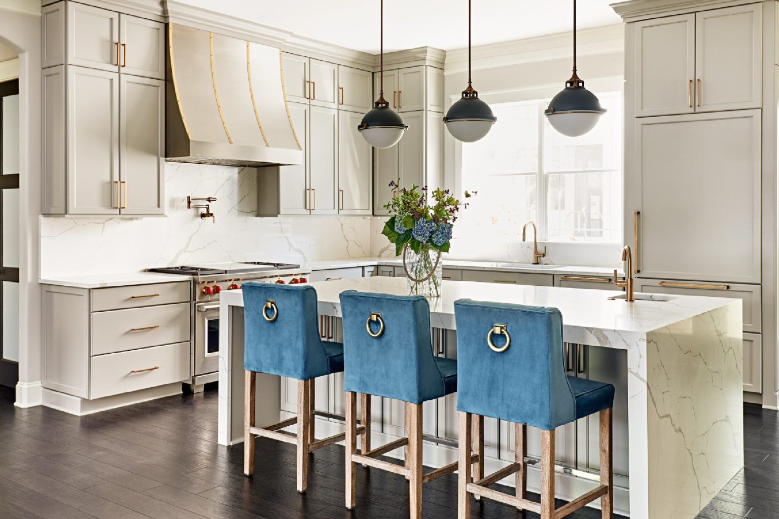 Updated white kitchen with vintage-style blue stool seating at the island.