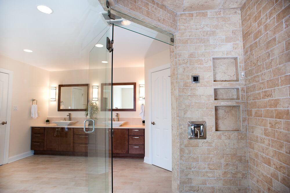 In-home spa bathroom in Charlotte with glass-enclosed shower and double vanity.