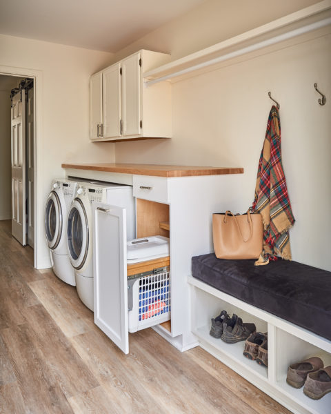 laundry room remodel open cabinetry cushioned bench shoe storage hanging hooks wood work shelf