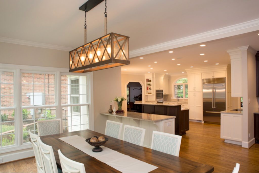 Large open-concept kitchen with two islands, two sink areas, and a massive sun-filled eating area