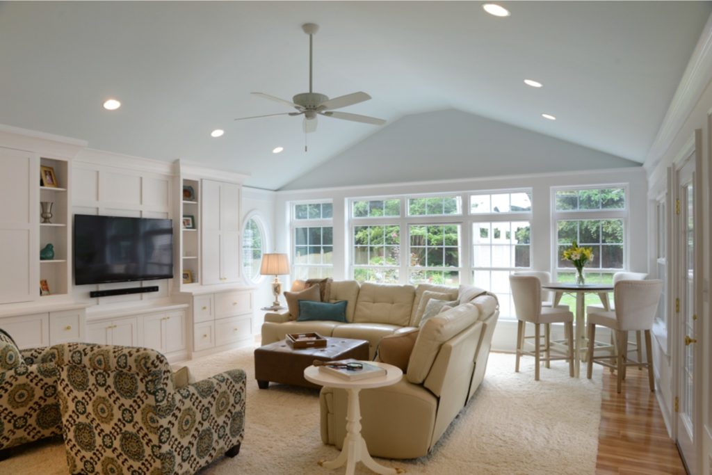 Southern sunroom/bonus room addition with floor-to-ceiling windows and wall-to-wall entertainment cabinetry