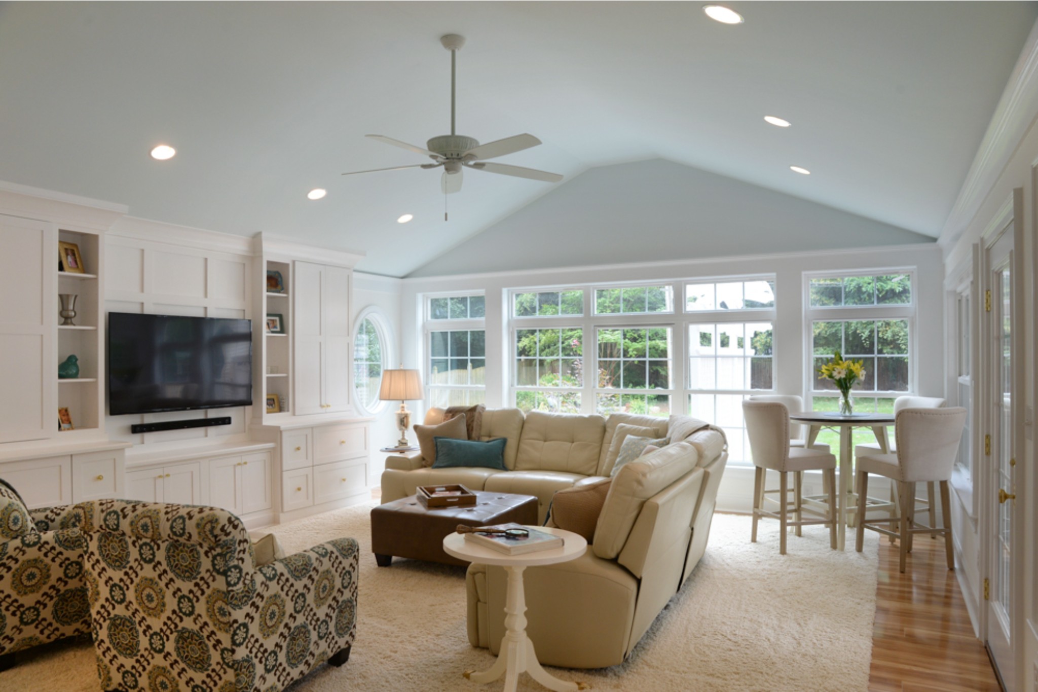 Southern sunroom/bonus room addition with floor-to-ceiling windows and wall-to-wall entertainment cabinetry