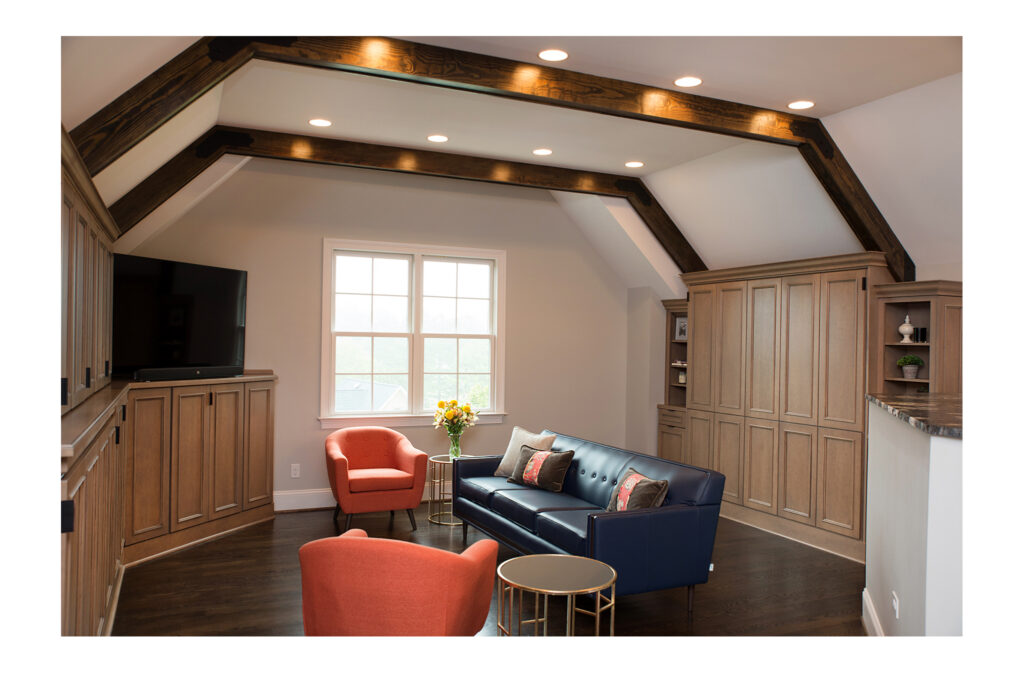 Attic converted into bonus room with custom cabinetry and built-in murphy beds