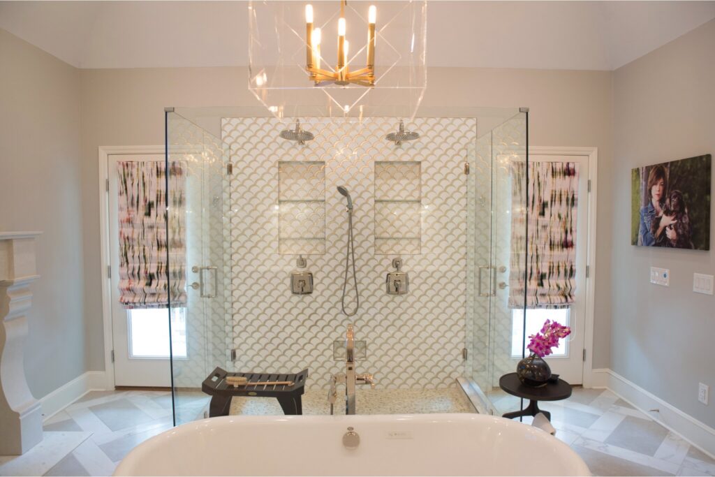 Bathroom remodel with chandelier over soaking tub and a separate large glass shower