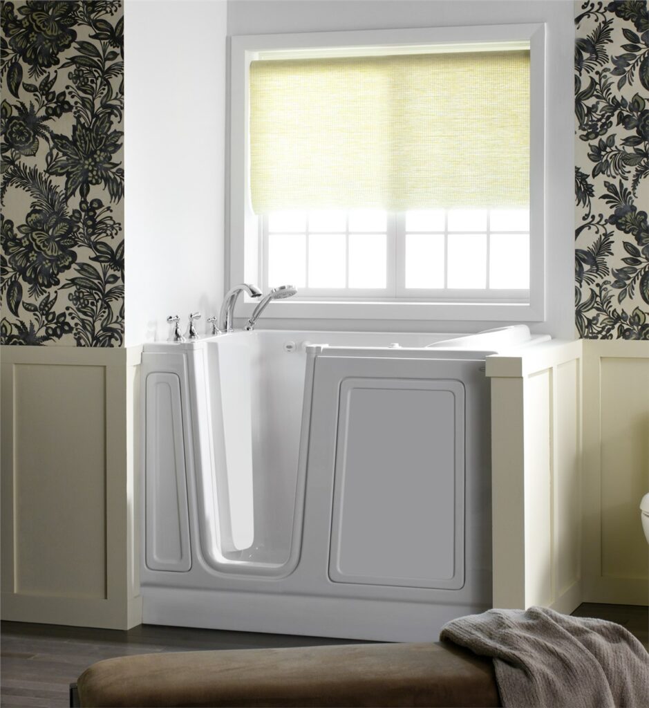 Walk-in safety tub in wallpapered bathroom