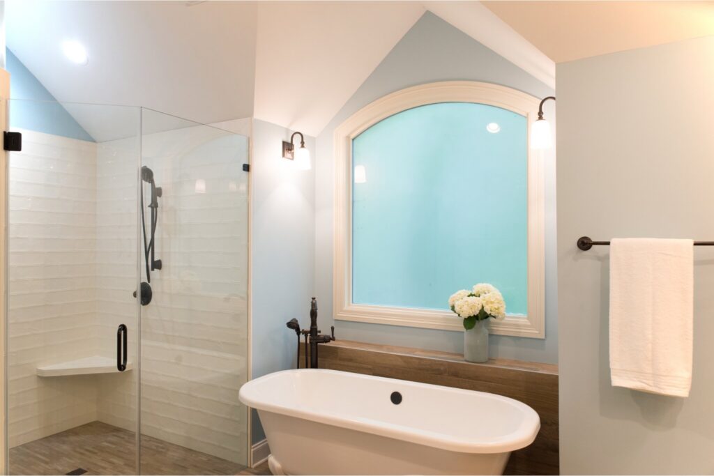 Large glazed window with free standing tub under