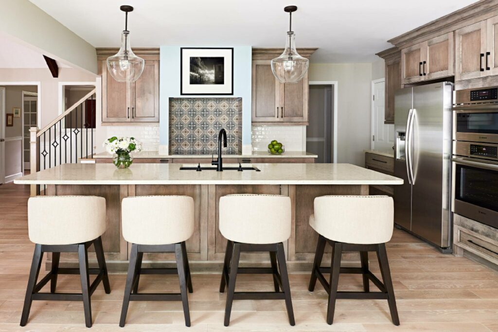 Kitchen remodel with glass pendant lights, and morrocan tiled area above the stove
