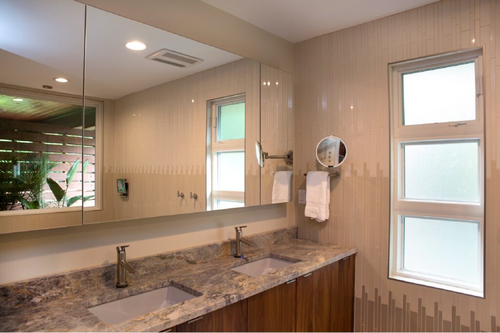 Bathroom remodel with large mirror and obre tiling