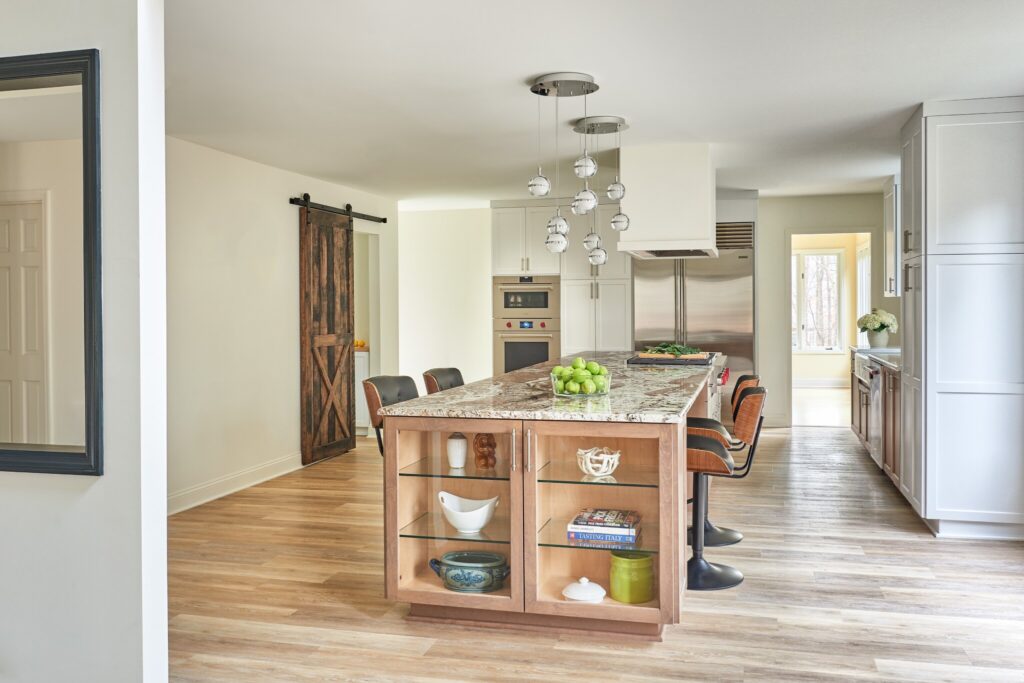 Modern kitchen with granite island, barstools, and stainless steel appliances